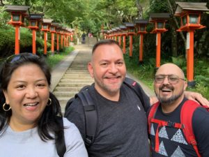 Photo of the Board of Reiki Centers of America, Brian Brunius, Diane Domondon, and Christopher Tellez on the steps of Mount Kurama in 2019.